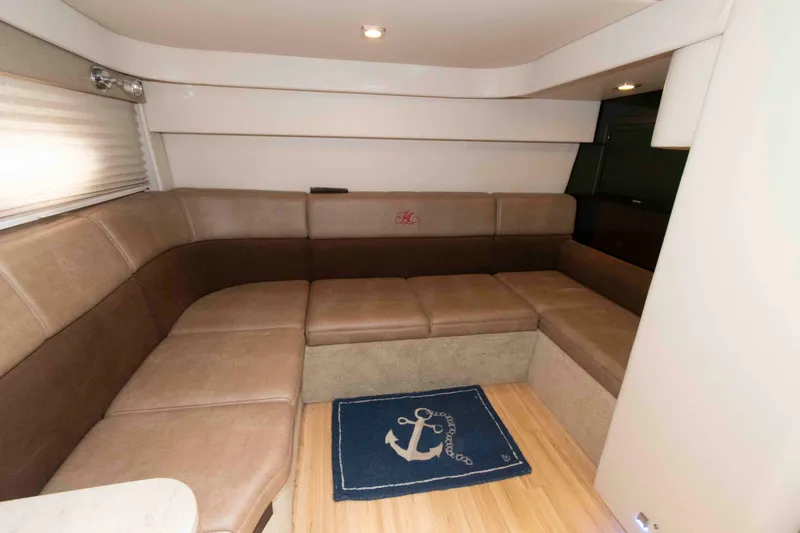Slide: The Image of Interior of 2014 Formula 40 Performance Cruiser with beige seating and anchor-themed rug. - 18