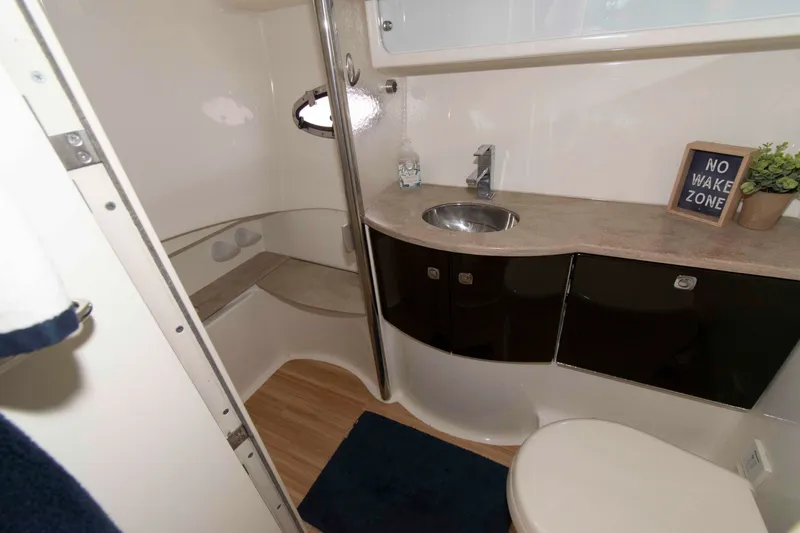 Slide: The Image of 2014 Formula 40 Performance Cruiser bathroom with sink, toilet, and "No Wake Zone" sign. - 19
