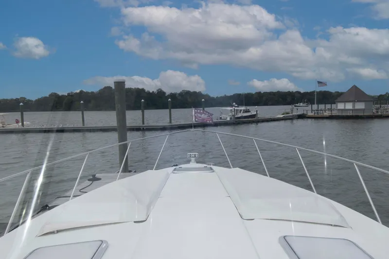Slide: The Image of 2014 Formula 40 Performance Cruiser approaching dock under blue sky. - 13