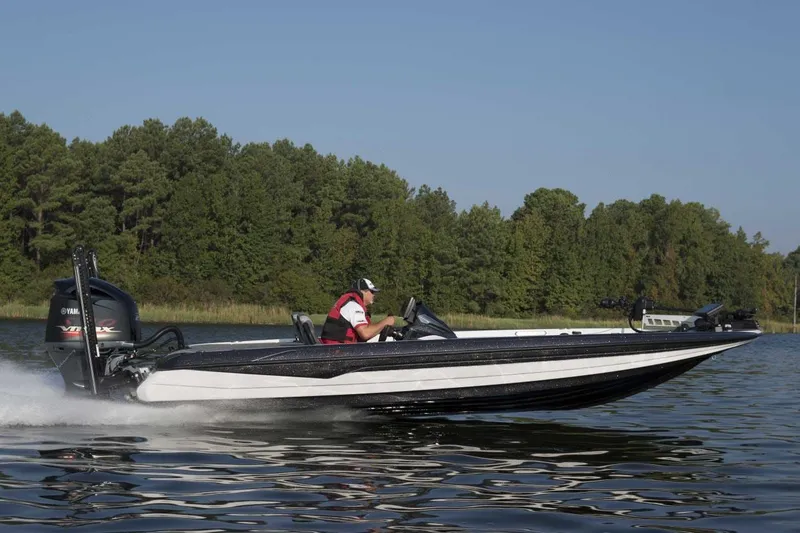 Slide: The Image of Manufacturer Provided Image: 2022 Skeeter FXR 21 boat speeding on a lake with forest background. - 14