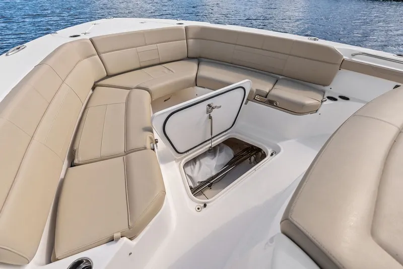 Slide: The Image of 2020 Pursuit S 408 Sport boat interior with beige seating and open storage compartment. - 45