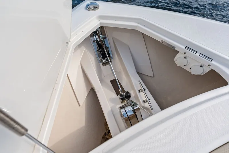 Slide: The Image of Anchor compartment of 2020 Pursuit S 408 Sport boat, featuring winch and storage. - 44