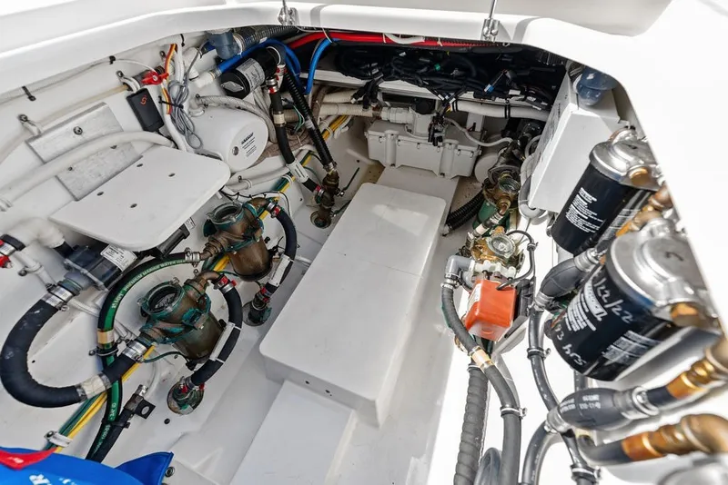 Slide: The Image of Engine compartment of 2020 Pursuit S 408 Sport boat, showcasing complex wiring and components. - 50