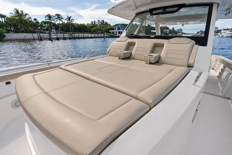 Slide: The Image of Luxurious seating on 2020 Pursuit S 408 Sport boat, docked by scenic waterfront. - 40