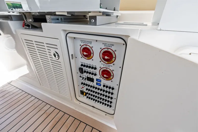 Slide: The Image of Control panel on a 2020 Pursuit S 408 Sport boat, featuring engine and electronics switches. - 36