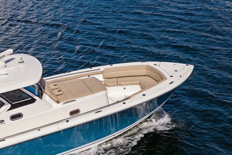 Slide: The Image of 2020 Pursuit S 408 Sport boat cruising on open water. - 6