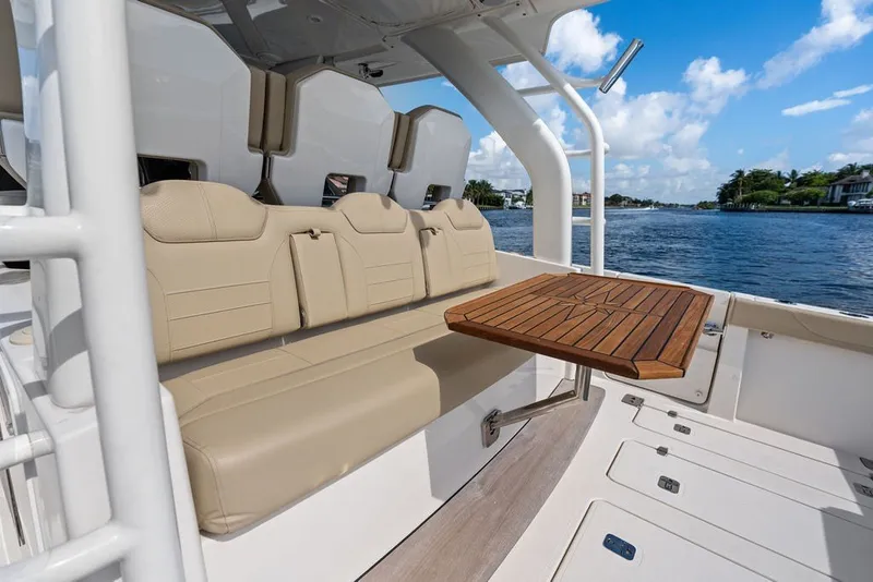 Slide: The Image of Luxurious seating and table on 2020 Pursuit S 408 Sport boat, with scenic water view. - 27