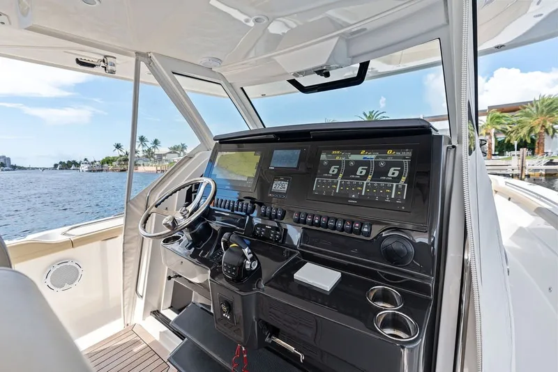Slide: The Image of 2020 Pursuit S 408 Sport boat cockpit with advanced navigation system and waterfront view. - 32
