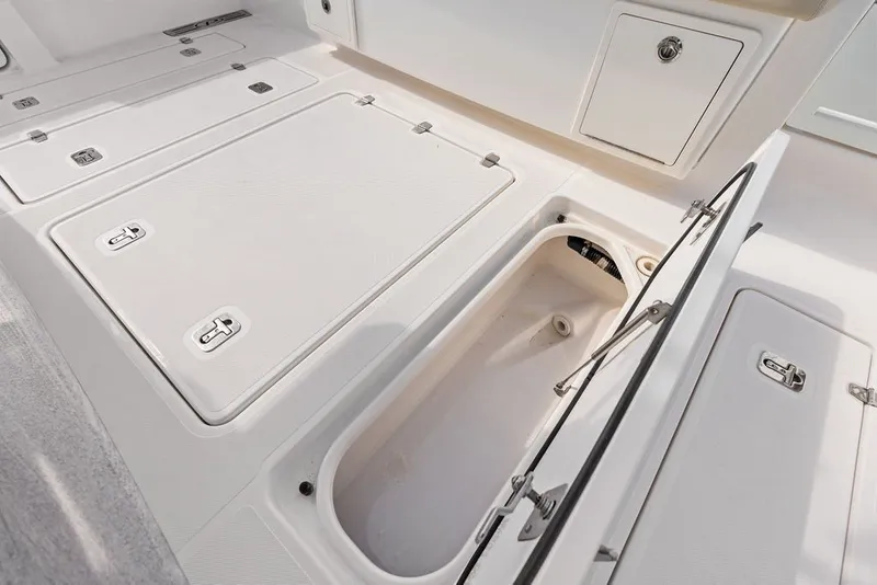 Slide: The Image of 2020 Pursuit S 408 Sport boat storage compartments and hatch details. - 25