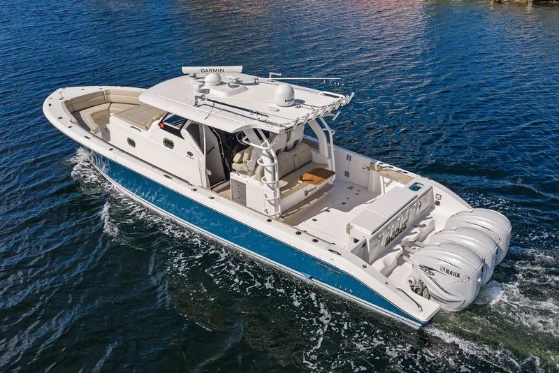 Slide: The Image of 2020 Pursuit S 408 Sport boat cruising on open water with triple Yamaha engines. - 1