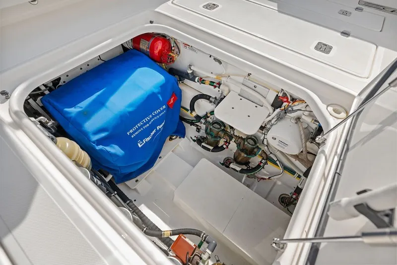 Slide: The Image of Engine compartment of 2020 Pursuit S 408 Sport boat with protective cover and fire extinguisher. - 48