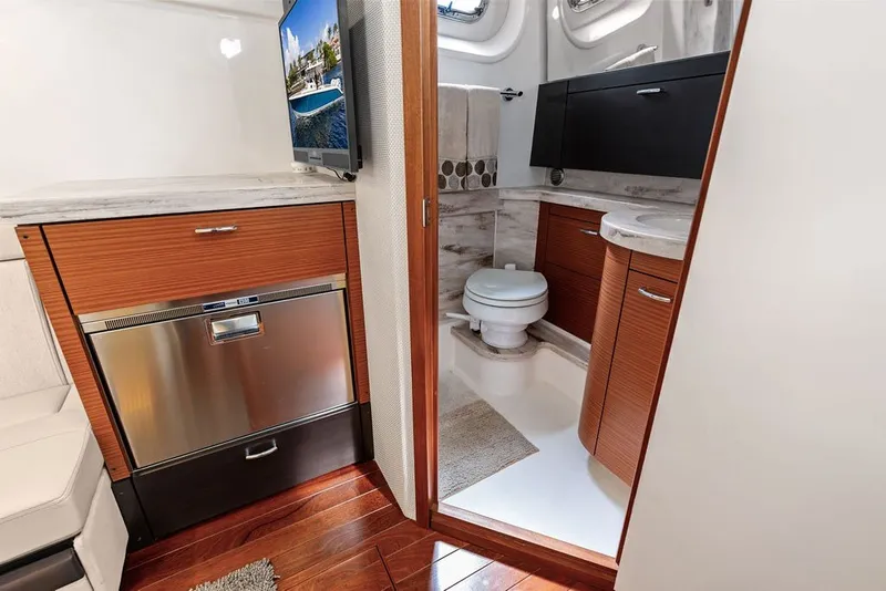 Slide: The Image of Luxurious 2020 Pursuit S 408 Sport yacht interior with modern bathroom and kitchenette. - 54