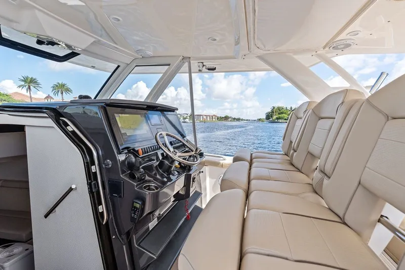 Slide: The Image of 2020 Pursuit S 408 Sport boat interior with luxurious seating and modern helm. - 28