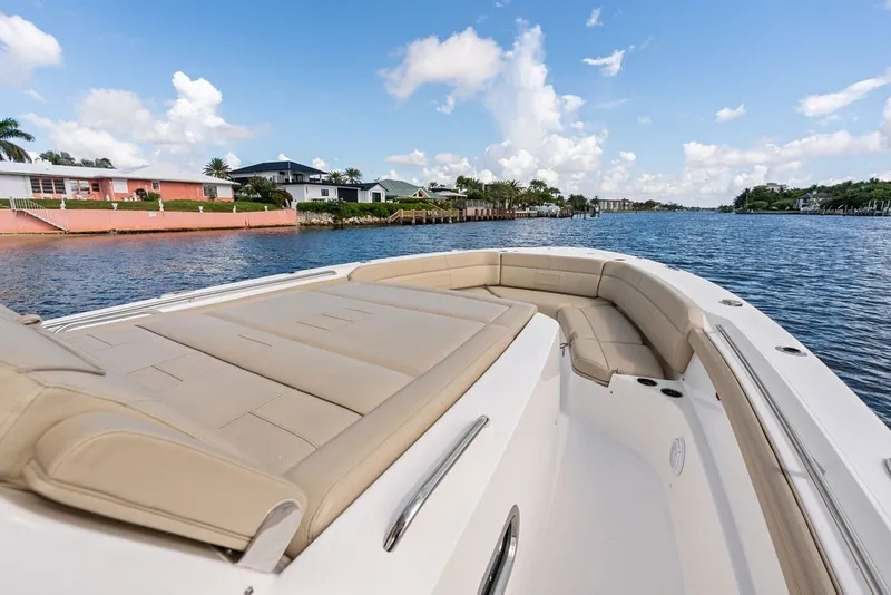 Slide: The Image of 2020 Pursuit S 408 Sport boat with spacious seating, cruising on a scenic waterway. - 39