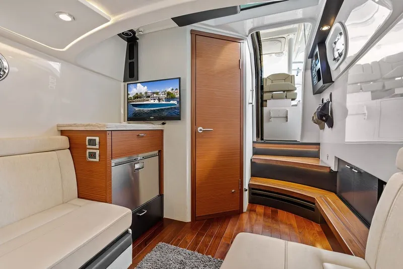 Slide: The Image of Luxurious interior of 2020 Pursuit S 408 Sport boat with modern amenities and wooden finishes. - 51