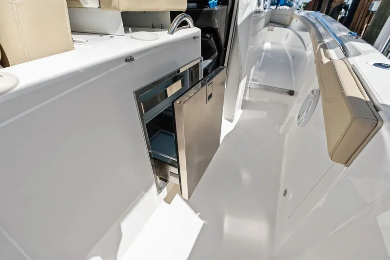 Slide: The Image of 2020 Pursuit S 408 Sport boat interior with open storage compartment. - 37