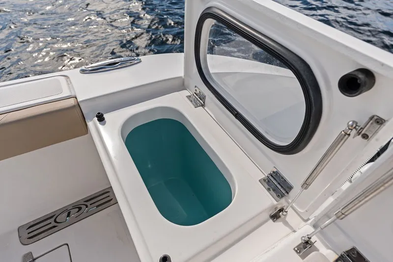 Slide: The Image of 2020 Pursuit S 408 Sport boat with open storage compartment by the water. - 21