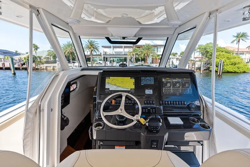 Slide: The Image of 2020 Pursuit S 408 Sport boat cockpit with advanced navigation system and waterfront view. - 35