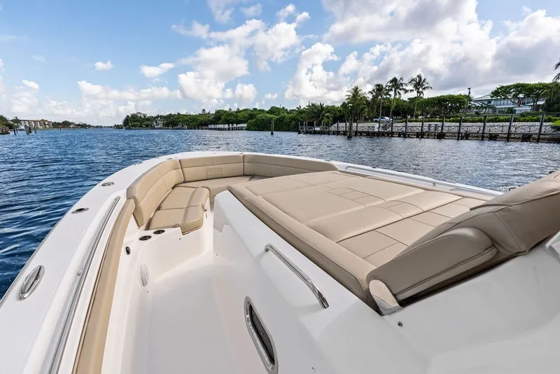 Slide: The Image of 2020 Pursuit S 408 Sport boat with luxurious seating on a scenic waterway. - 38