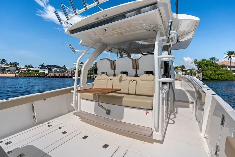 Slide: The Image of 2020 Pursuit S 408 Sport boat interior with seating and table on a sunny day. - 22