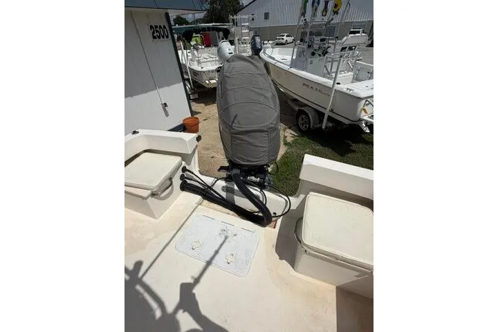 Slide: The Image of 2006 Parker 2100 Special Edition boat with covered outboard motor, docked outdoors. - 17