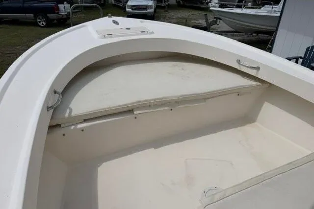 Slide: The Image of 2006 Parker 2100 Special Edition boat interior with white seating and storage area. - 9