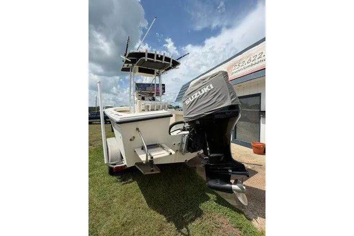 Slide: The Image of 2006 Parker 2100 Special Edition boat with Suzuki outboard motor, parked on grass. - 2
