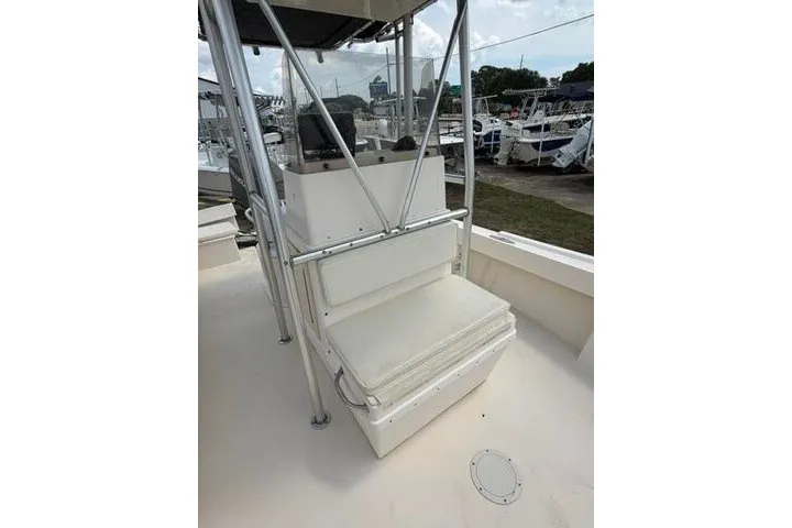 Slide: The Image of 2006 Parker 2100 Special Edition boat interior with seating and console, docked at marina. - 11