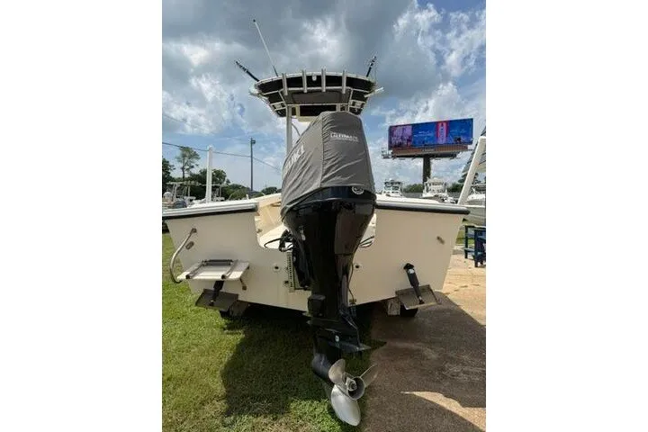 Slide: The Image of 2006 Parker 2100 Special Edition boat with Yamaha outboard motor, parked on grass. - 4