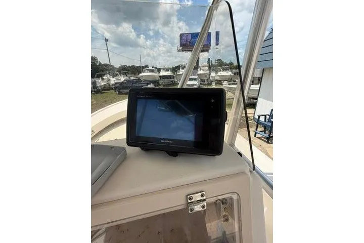 Slide: The Image of Garmin GPS device on 2006 Parker 2100 Special Edition boat dashboard, marina background. - 22