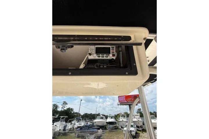 Slide: The Image of 2006 Parker 2100 Special Edition boat console with radio, docked among other boats. - 24