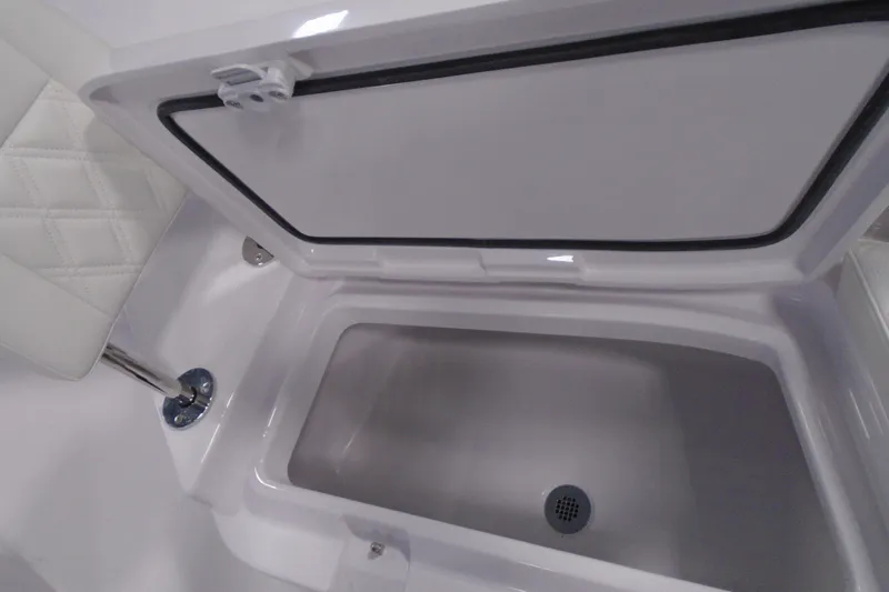 Slide: The Image of Open storage compartment on 2027 Striking Boats 27XB, featuring sleek white interior design. - 28