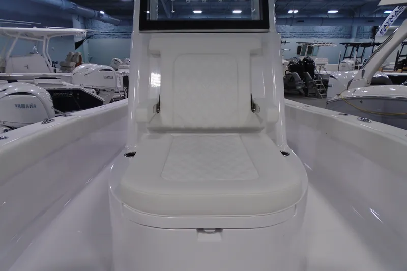 Slide: The Image of 2027 Striking Boats 27XB interior with white cushioned seating in a showroom. - 29