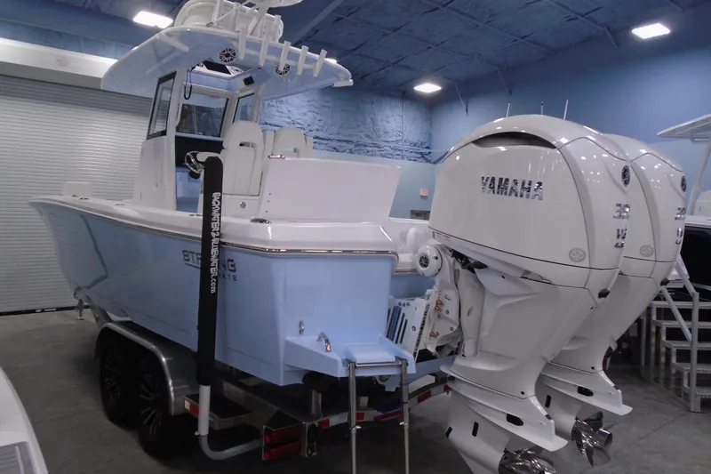 Slide: The Image of 2027 Striking Boats 27XB with dual Yamaha engines in a showroom setting. - 17