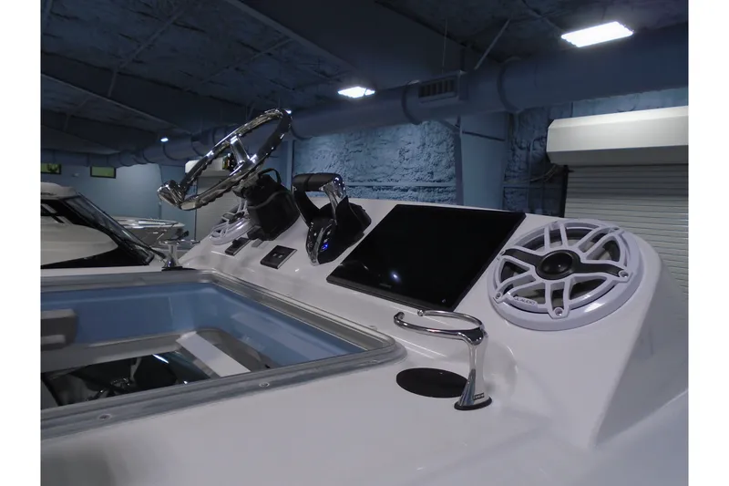 Slide: The Image of Control panel of 2027 Striking Boats 27XB with steering wheel and modern electronics. - 31