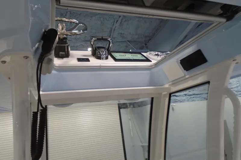 Slide: The Image of Interior view of 2027 Striking Boats 27XB cockpit with modern controls and steering wheel. - 20