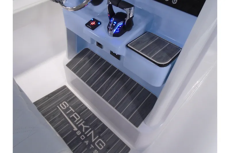 Slide: The Image of Interior of 2027 Striking Boats 27XB, featuring sleek controls and branded flooring. - 32