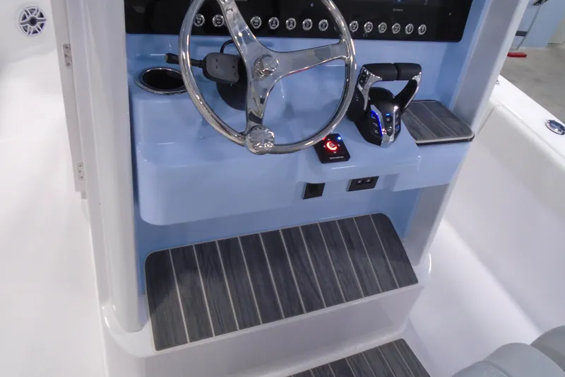 Slide: The Image of 2027 Striking Boats 27XB helm with modern steering wheel and controls. - 18