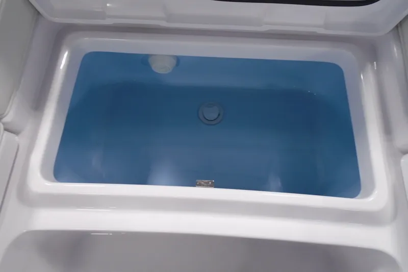 Slide: The Image of Livewell compartment in 2027 Striking Boats 27XB model, featuring a clean, blue interior. - 26