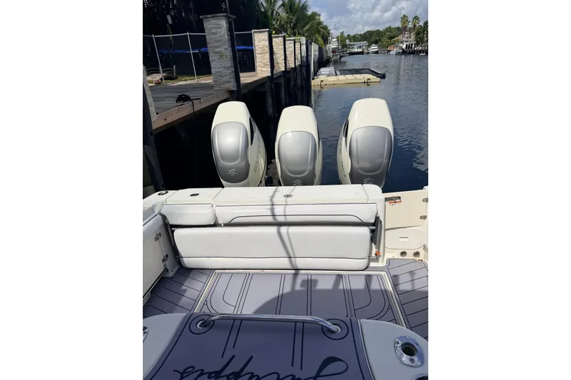Slide: The Image of 2005 Hydra-Sports Vector 3300 VX boat with triple outboard engines docked by a canal. - 15
