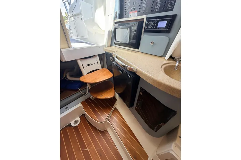 Slide: The Image of 2005 Hydra-Sports Vector 3300 VX cabin interior with wooden steps and kitchenette. - 28