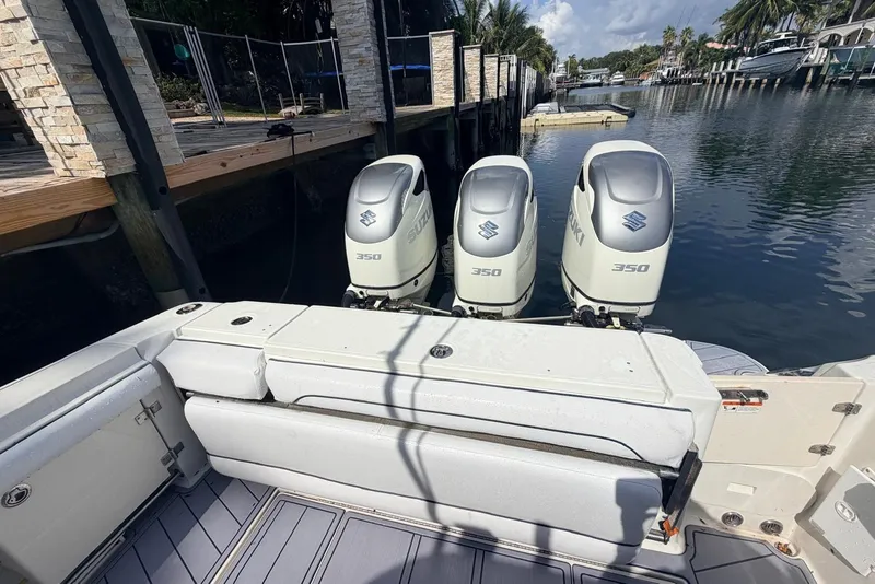 Slide: The Image of 2005 Hydra-Sports Vector 3300 VX with triple Suzuki 350 outboard engines docked by a canal. - 3