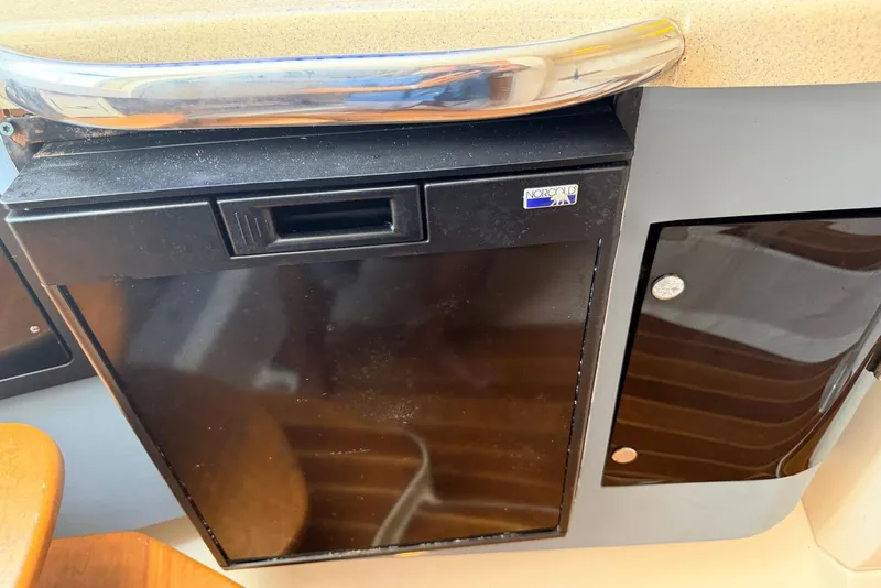 Slide: The Image of 2005 Hydra-Sports Vector 3300 VX interior with Norcold refrigerator and storage cabinet. - 25