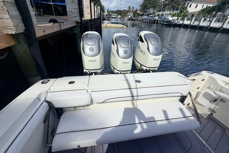 Slide: The Image of 2005 Hydra-Sports Vector 3300 VX with triple Suzuki 350 engines docked by waterfront homes. - 2