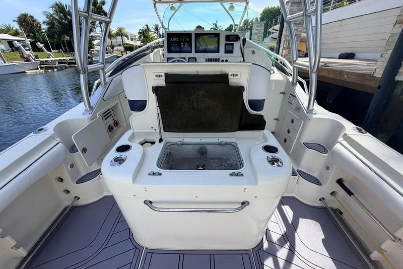 Slide: The Image of 2005 Hydra-Sports Vector 3300 VX boat interior with open storage and control panel. - 8