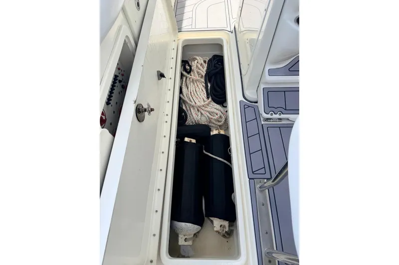 Slide: The Image of Storage compartment on a 2005 Hydra-Sports Vector 3300 VX boat with ropes and fenders. - 12