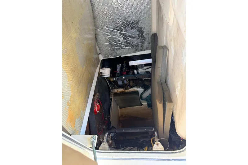 Slide: The Image of 2005 Hydra-Sports Vector 3300 VX engine compartment with visible components and insulation. - 16