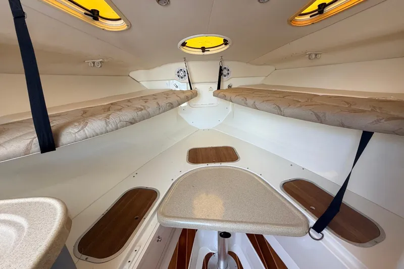 Slide: The Image of 2005 Hydra-Sports Vector 3300 VX cabin interior with cushioned seating and storage compartments. - 26