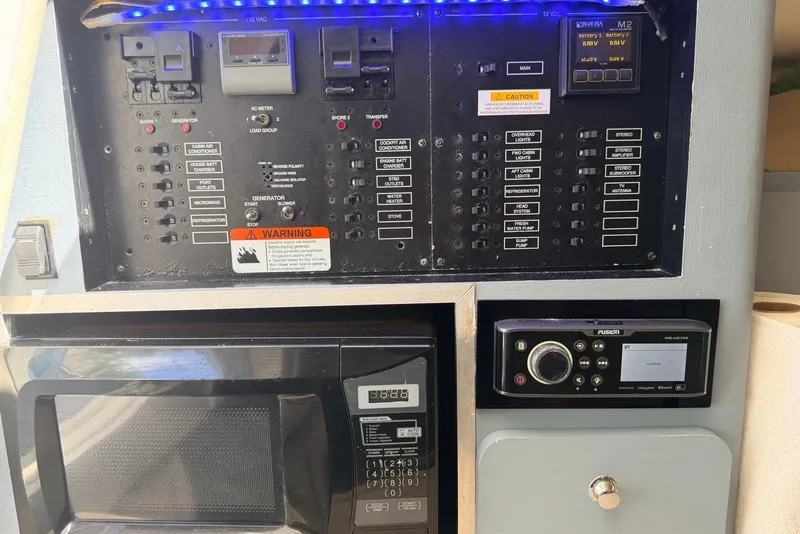 Slide: The Image of Control panel and microwave in a 2005 Hydra-Sports Vector 3300 VX boat. - 24