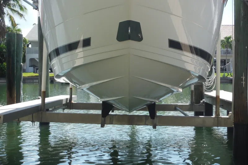 Slide: The Image of 2024 Monterey 255SS Super Sport boat on lift, docked by waterfront home. - 43